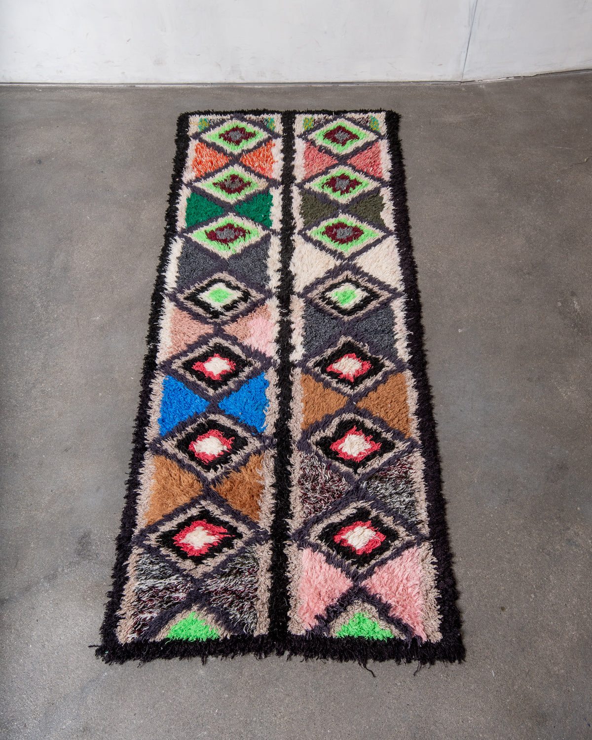 Modern designer vintage handcrafted Berber rug from Morocco. Boucherouite runner rug with beautiful colors and patterns.